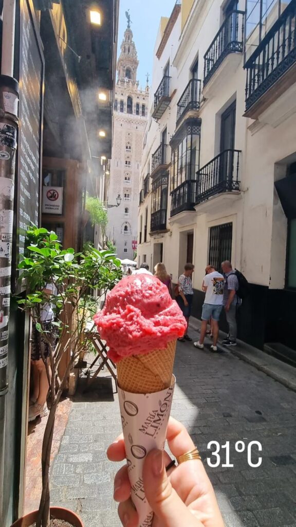 Mostrando ruas estreitas de Sevilha e um sorve e minha mao