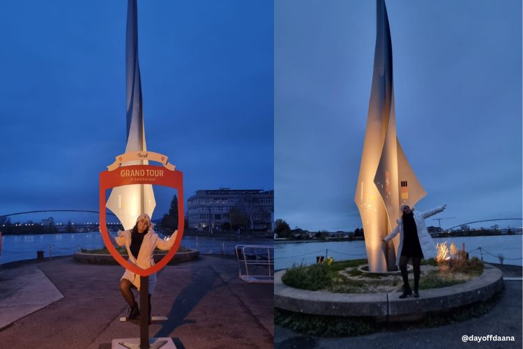 Ana em uma moldura fotográfica no Dreiländereck, com o monumento e o Rio Reno ao fundo, simbolizando a união entre Suíça, França e Alemanha."  Imagem 2: "Ana em frente ao monumento do Dreiländereck, com os braços abertos, mostrando as três bandeiras dos países: Suíça, França e Alemanha.